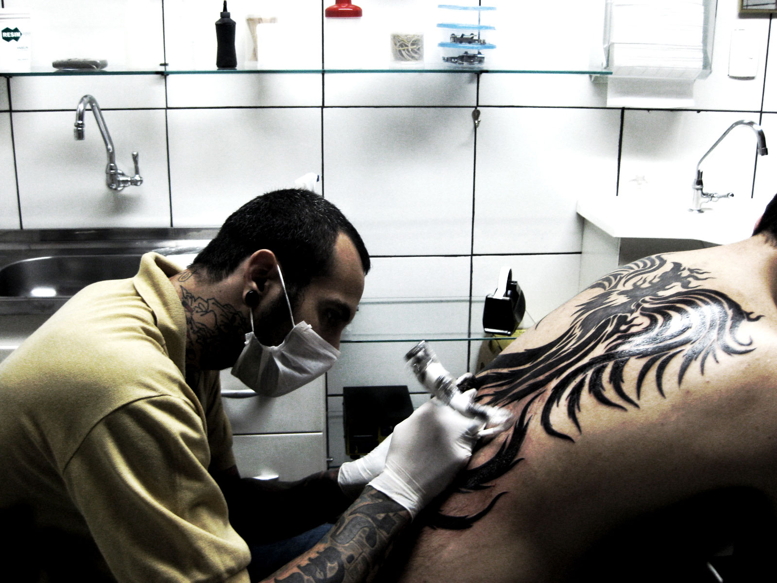 A man tattooing a tribal